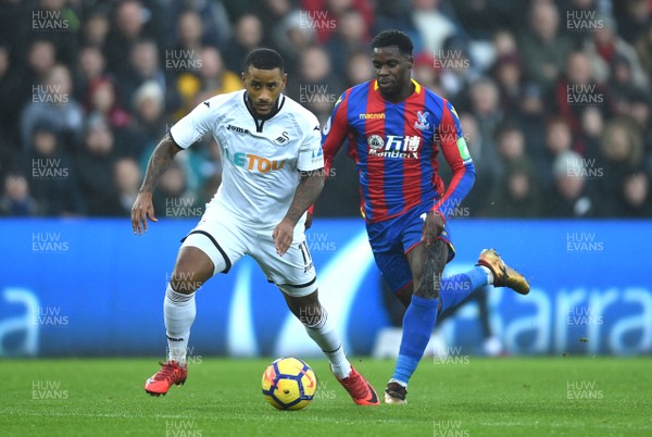 231217 - Swansea City v Crystal Palace - Premier League - Luciano Narsingh of Swansea City is tackled by Jeffrey Schlupp of Crystal Palace