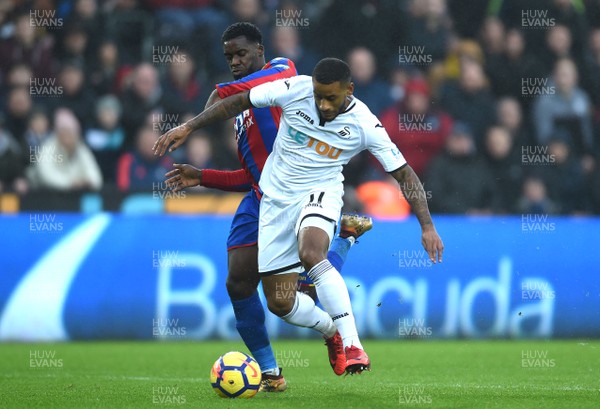 231217 - Swansea City v Crystal Palace - Premier League - Luciano Narsingh of Swansea City is tackled by Jeffrey Schlupp of Crystal Palace