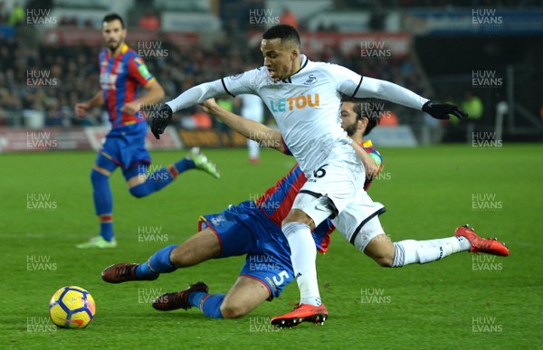 231217 - Swansea City v Crystal Palace - Premier League - Martin Olsson of Swansea City is tackled by James Tomkins of Crystal Palace