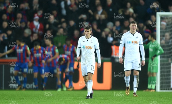 231217 - Swansea City v Crystal Palace - Premier League - Tom Carroll and Alfie Mawson of Swansea City look dejected after Crystal Palace goal