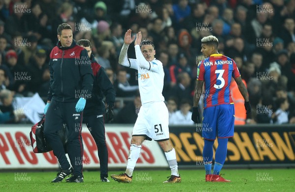 231217 - Swansea City v Crystal Palace - Premier League - Roque Mesa of Swansea City leaves the field with medical staff