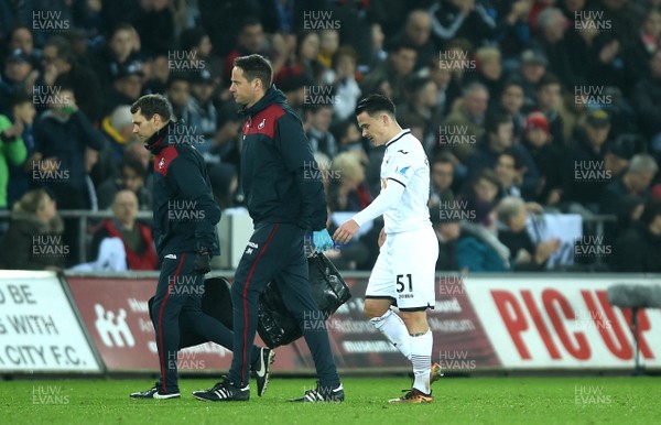 231217 - Swansea City v Crystal Palace - Premier League - Roque Mesa of Swansea City leaves the field with medical staff