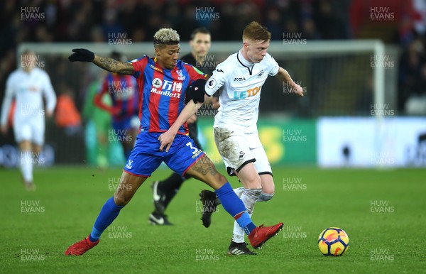 231217 - Swansea City v Crystal Palace - Premier League - Alfie Mawson of Swansea City is tackled by Patrick van Aanholt of Crystal Palace