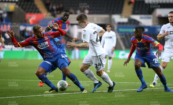 280818 - Swansea City v Crystal Palace - Carabao Cup - Declan John of Swansea City is challenged by Jaro Riedewald of Crystal Palace