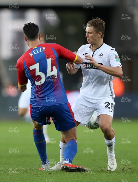 280818 - Swansea City v Crystal Palace - Carabao Cup - George Byers of Swansea City is tackled by Martin Kelly of Crystal Palace