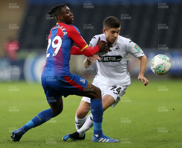 280818 - Swansea City v Crystal Palace - Carabao Cup - Declan John of Swansea City is tackled by Aaron Wan-Bissaka of Crystal Palace