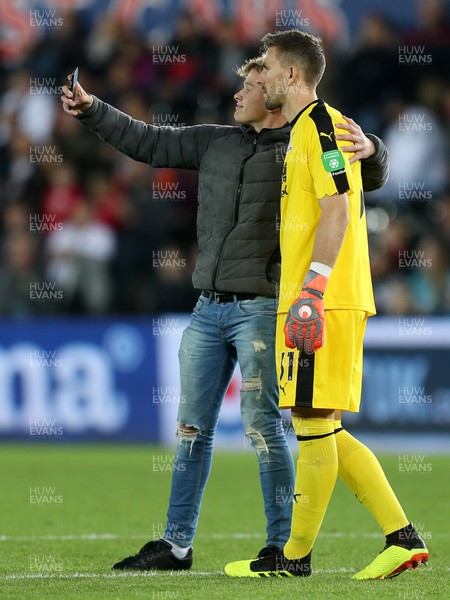 280818 - Swansea City v Crystal Palace - Carabao Cup - A fan runs onto the pitch to have a selfie with Vicente Guaita of Crystal Palace