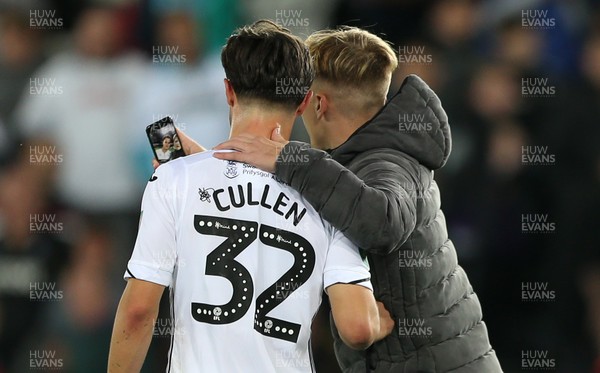 280818 - Swansea City v Crystal Palace - Carabao Cup - A fan runs onto the pitch to have a selfie with Liam Cullen of Swansea City