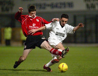 040203 - Swansea City v Darlington - Third Division - Swansea's Leon Britton is tackled by Neil Wainwright