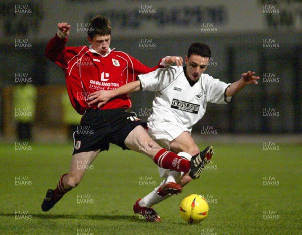 040203 - Swansea City v Darlington - Third Division - Swansea's Leon Britton is tackled by Neil Wainwright