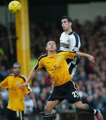 221103 - Swansea City v Darlington - Swansea's Daniel Nardiello climbs above Jonathan Hutchinson to head at goal