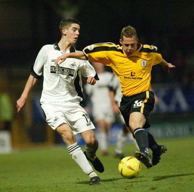 221103 - Swansea City v Darlington - Swansea's Richard Duffy tangles with Mark Convery