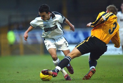 221103 - Swansea City v Darlington - Swansea's Leon Britton beats Craig James 