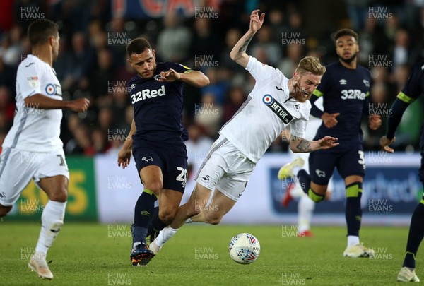 010519 - Swansea City v Derby County - SkyBet Championship - Oli McBurnie of Swansea City is tackled by Mason Bennett of Derby