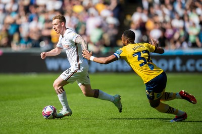 050425 - Swansea City v Derby County - Sky Bet Championship - Lewis O’Brien of Swansea City beats Ebou Adams of Derby County