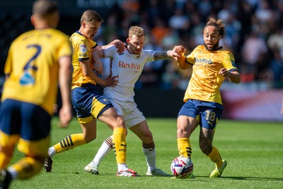 050425 - Swansea City v Derby County - Sky Bet Championship - Lewis O’Brien of Swansea City is tackled by Marcus Harness of Derby County and Harrison Armstrong of Derby County