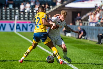 050425 - Swansea City v Derby County - Sky Bet Championship - Lewis O’Brien of Swansea City is tackled by Ebou Adams of Derby County