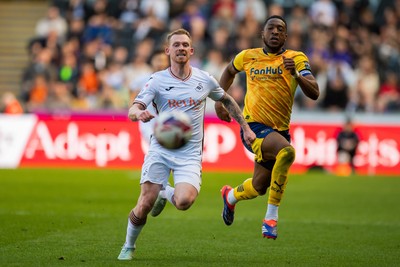 050425 - Swansea City v Derby County - Sky Bet Championship - Lewis O’Brien of Swansea City and Ebou Adams of Derby County compete for the ball