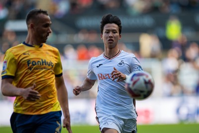 050425 - Swansea City v Derby County - Sky Bet Championship - Jisung Eom of Swansea City and Kane Wilson of Derby County compete for the ball 