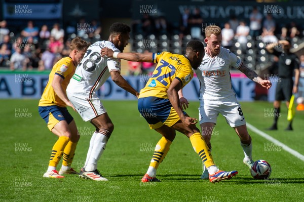 050425 - Swansea City v Derby County - Sky Bet Championship - Lewis O’Brien of Swansea City is tackled by Ebou Adams of Derby County