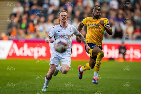 050425 - Swansea City v Derby County - Sky Bet Championship - Lewis O’Brien of Swansea City and Ebou Adams of Derby County compete for the ball