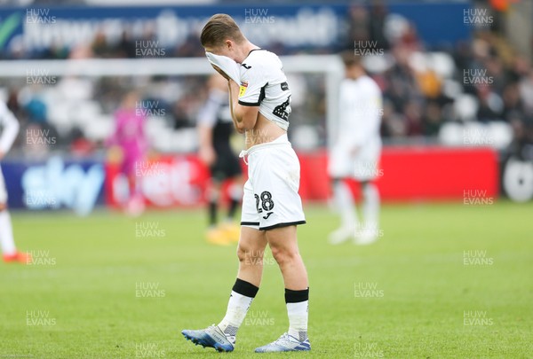 080220 - Swansea City v Derby County, Sky Bet Championship - George Byers of Swansea City holds his head as he limps off with an injury at the end of the first half