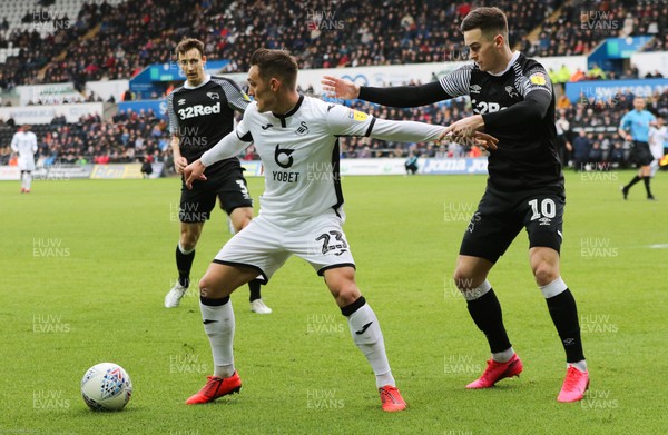 080220 - Swansea City v Derby County, Sky Bet Championship - Connor Roberts of Swansea City holds off Tom Lawrence of Derby County