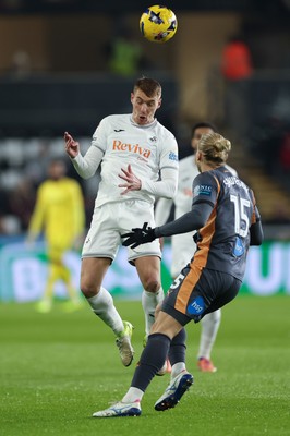 251125 - Swansea City v Derby County, EFL Sky Bet Championship - Jay Fulton of Swansea City heads past Lars-Jorgen Salvesen of Derby County