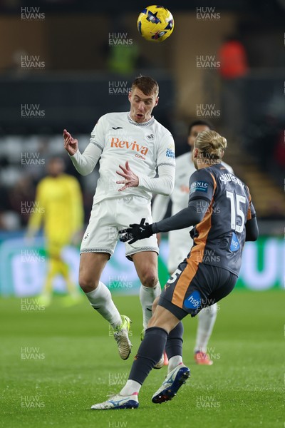 251125 - Swansea City v Derby County, EFL Sky Bet Championship - Jay Fulton of Swansea City heads past Lars-Jorgen Salvesen of Derby County
