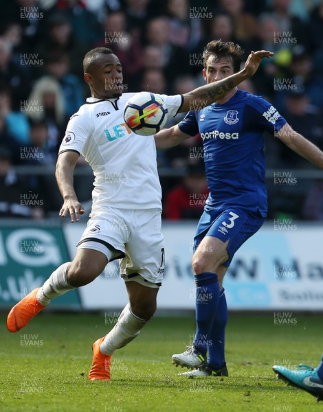 140418 - Swansea City v Everton - Premier League - Jordan Ayew of Swansea is challenged by Leighton Baines of Everton