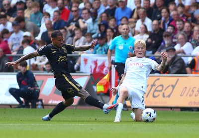 020825 - Swansea City v FC Lorient - Preseason Friendly - Melker Widell of Swansea City challenges Mohamad Bamba of FC Loreient for the ball