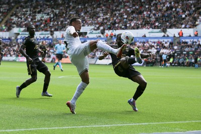 020825 - Swansea City v FC Lorient - Preseason Friendly - Ronald of Swansea City takes on Darlin Yogwa of FC Lorient