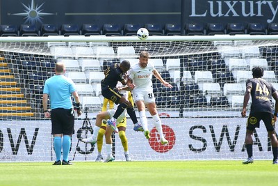 020825 - Swansea City v FC Lorient - Preseason Friendly - Cameron Burgess of Swansea City outjumps Gedeon Kalulu of FC Lorient