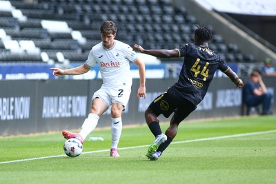 020825 - Swansea City v FC Lorient - Preseason Friendly - Josh Key of Swansea City takes on Darlin Yogwa of FC Lorient