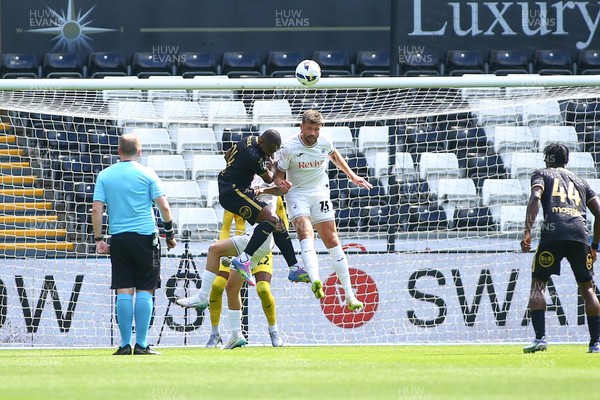 020825 - Swansea City v FC Lorient - Preseason Friendly - Cameron Burgess of Swansea City outjumps Gedeon Kalulu of FC Lorient