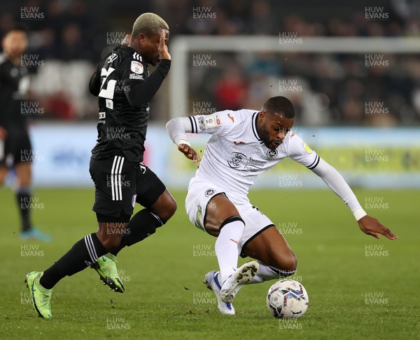 080322 - Swansea City v Fulham - SkyBet Championship - Olivier Ntcham of Swansea City is tackled by Jean Michael Seri of Fulham