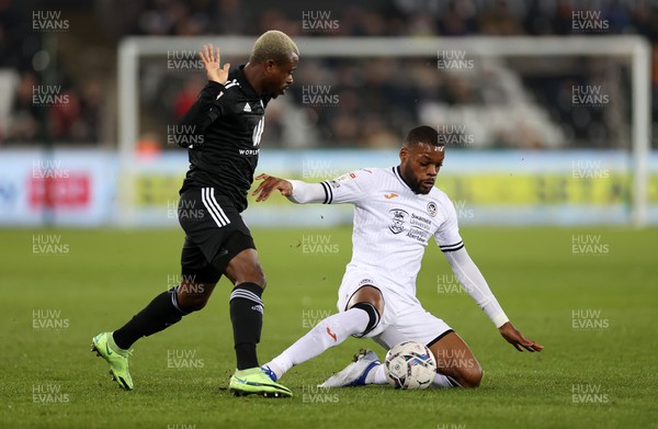 080322 - Swansea City v Fulham - SkyBet Championship - Olivier Ntcham of Swansea City is tackled by Jean Michael Seri of Fulham