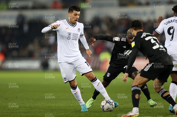 080322 - Swansea City v Fulham - SkyBet Championship - Joel Piroe of Swansea City is challenged by Antonee Robinson of Fulham