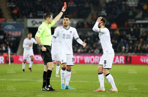 080322 - Swansea City v Fulham - SkyBet Championship - Joel Piroe and Matt Grimes of Swansea City plead with referee Jarred Gillett after he sends Ryan Manning of Swansea City off the pitch for his tackle on Harry Wilson of Fulham