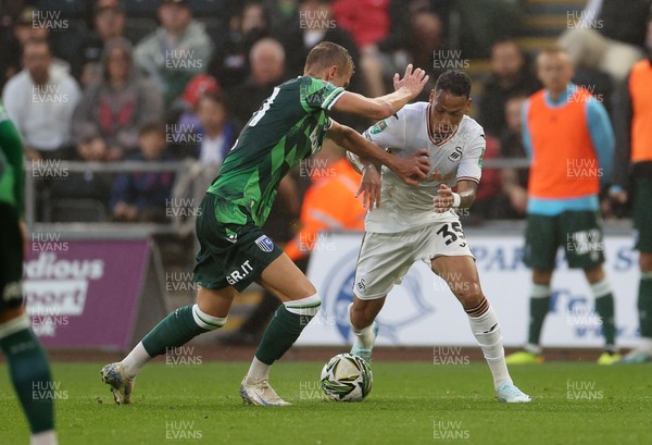 130824 - Swansea City v Gillingham - Carabao Cup - Ronald of Swansea City is challenged by Alex Giles of Gillingham 