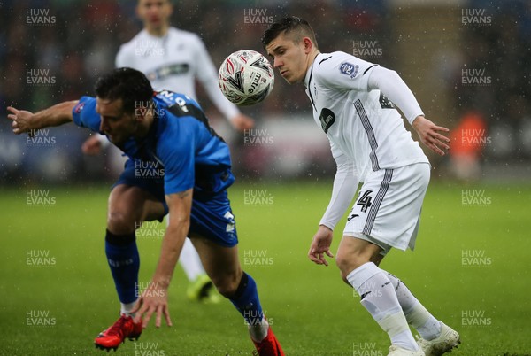 260119 -  Swansea City v Gillingham, FA Cup Fourth Round - Declan John of Swansea City and Luke O'Neill of Gillingham compete for the ball