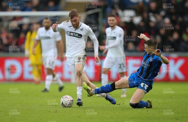 260119 -  Swansea City v Gillingham, FA Cup Fourth Round - Oli McBurnie of Swansea City is challenged by Mark Byrne of Gillingham