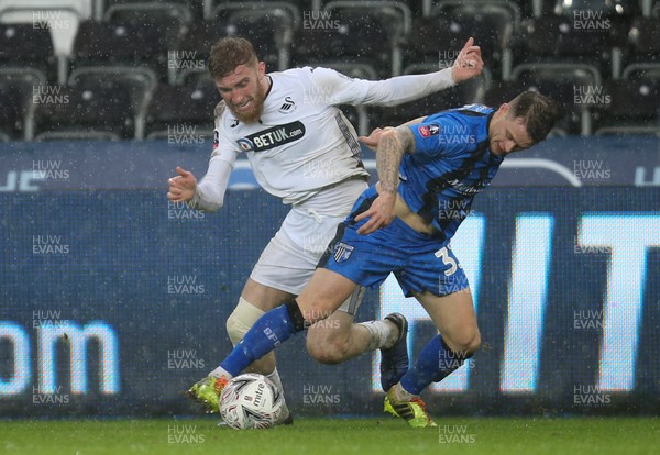 260119 -  Swansea City v Gillingham, FA Cup Fourth Round - Oli McBurnie of Swansea City and Mark Byrne of Gillingham compete for the ball