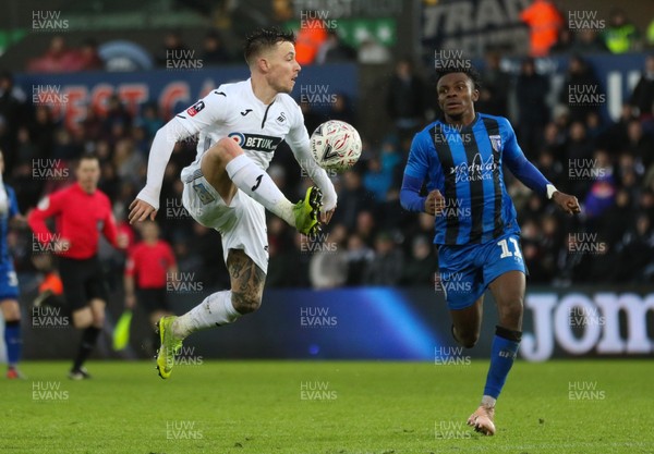 260119 -  Swansea City v Gillingham, FA Cup Fourth Round - Barrie McKay of Swansea City wins the ball as Regan Charles-Cook of Gillingham closes in