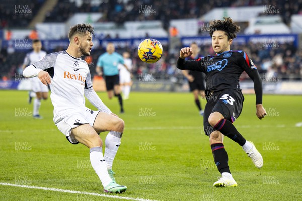 021223 - Swansea City v Huddersfield Town - Sky Bet Championship - Liam Cullen of Swansea City in action against Yuta Nakayama of Huddersfield Town