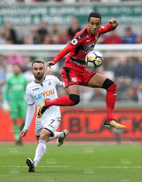 141017 - Swansea City v Huddersfield Town - Premier League - Thomas Ince of Huddersfield Town gets to the ball before Leon Britton of Swansea City