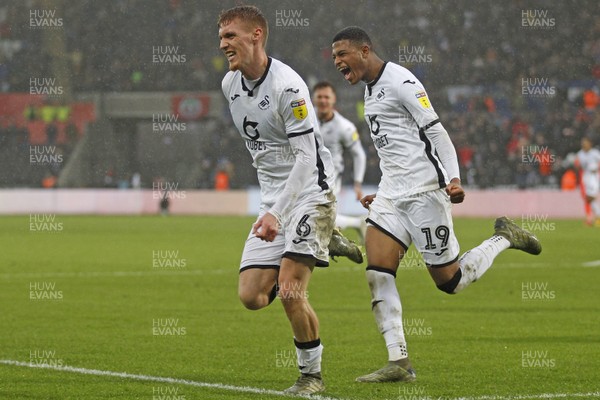 220220 - Swansea City v Huddersfield Town, Sky Bet Championship - Jay Fulton of Swansea City (left) celebrates scoring his side's second goal with Rhian Brewster