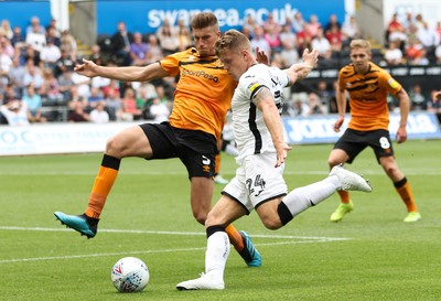 030819 - Swansea City v Hull City, Sky Bet Championship - Jake Bidwell of Swansea City crosses as Reece Burke of Hull City challenges