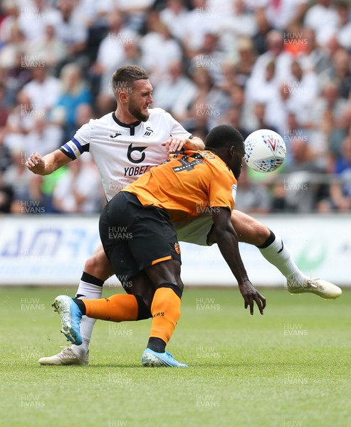030819 - Swansea City v Hull City, Sky Bet Championship - Matt Grimes of Swansea City and Nouha Dicko of Hull City compete for the ball