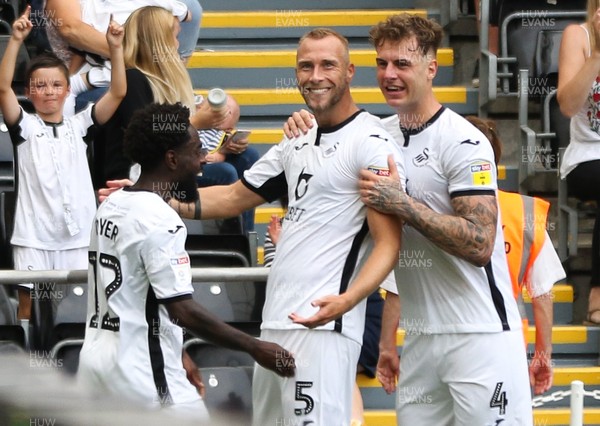 030819 - Swansea City v Hull City, Sky Bet Championship - Mike van der Hoorn of Swansea City celebrates with Nathan Dyer of Swansea City and Joe Rodon of Swansea City afters coring the second goal